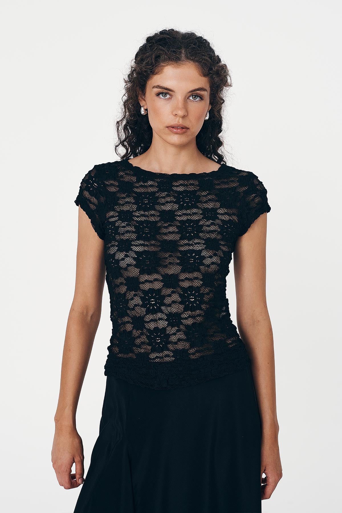 Model wears Galo Sunflower Lace Tee in Black paired with Marina Silk Midi Skirt in Black
