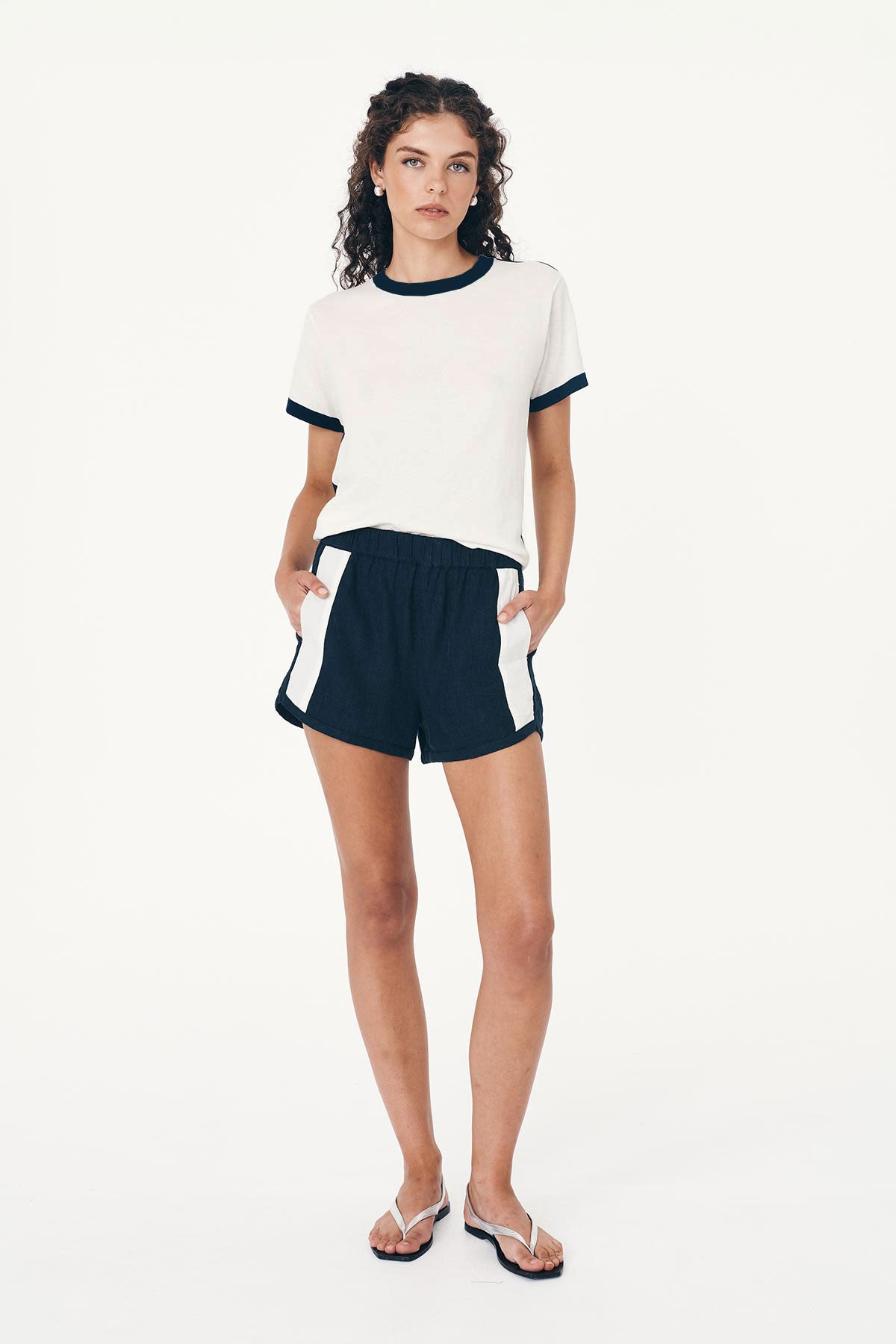 Model wearing Simone Linen Shorts in Ink, styled with the Rania Contrast Knit Tee in Ink by ROWIE the Label, front studio view.