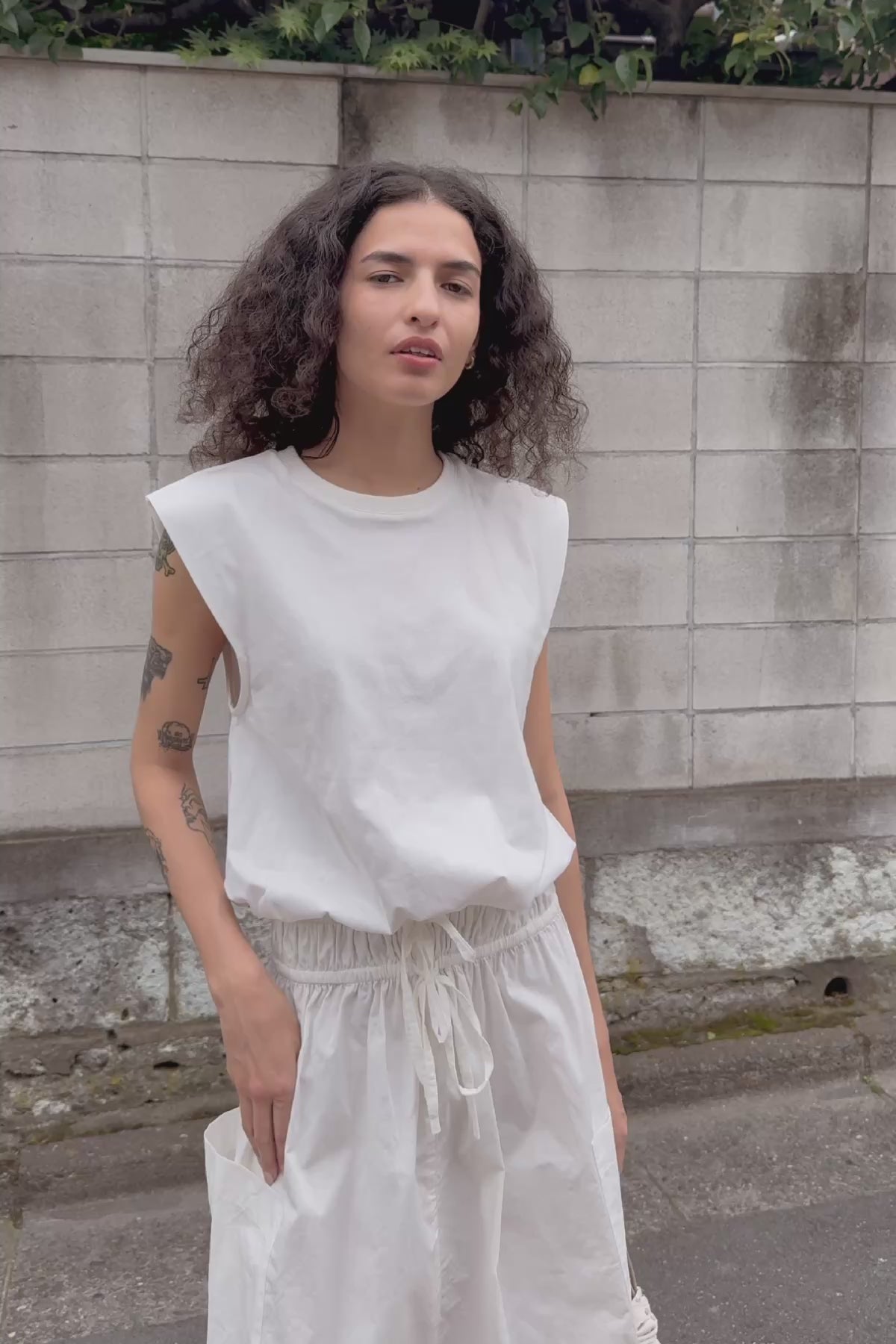 Video of model wearing a Jessica Organic Midi Dress in Tonal Bone by ROWIE the Label, filmed on a Tokyo street.