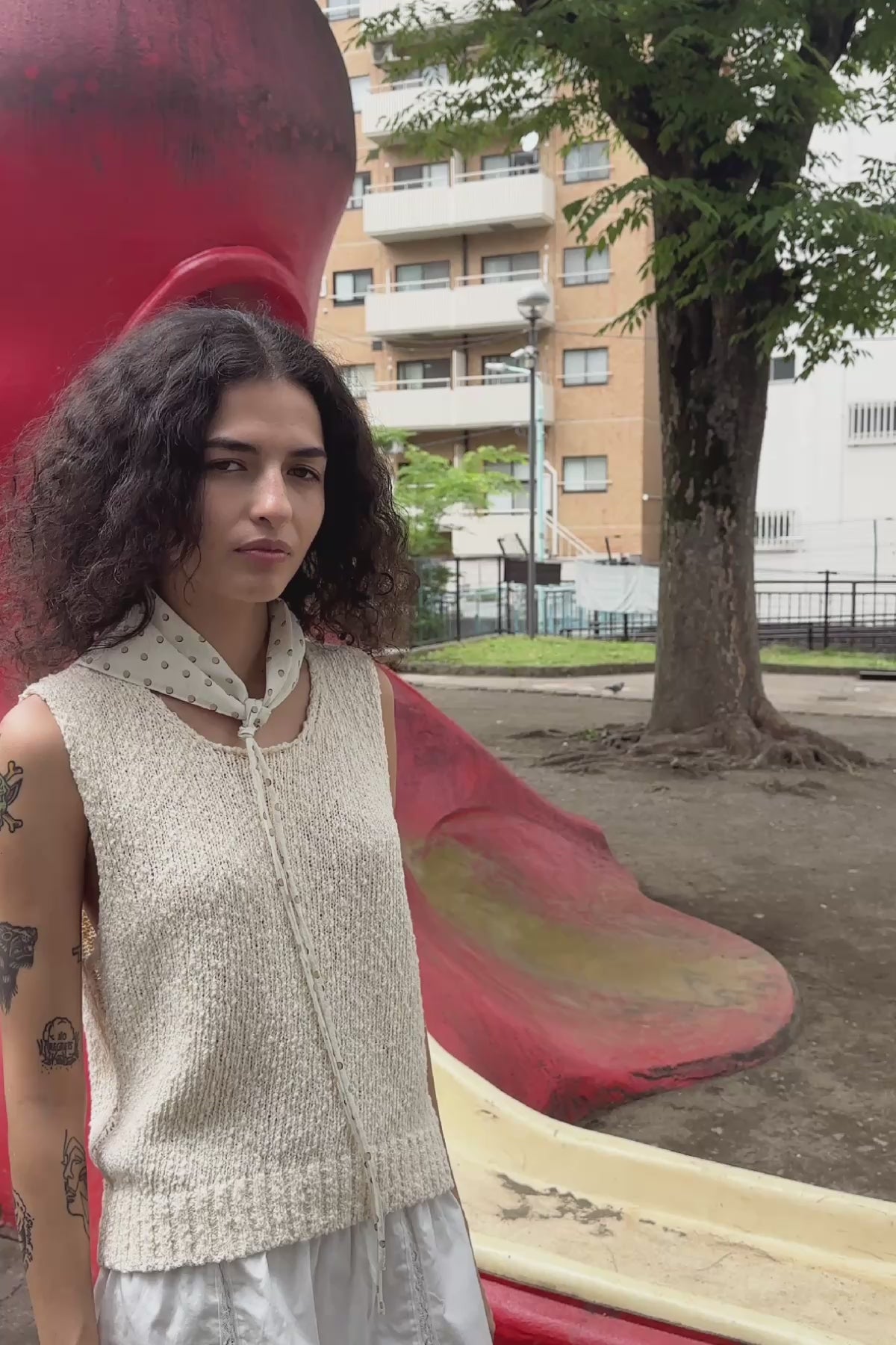 Video of model wearing a Suri Lace Mini Skirt in Bone, styled with the Catalina Knit Tank in Creme by ROWIE the Label, filmed in a Tokyo park.