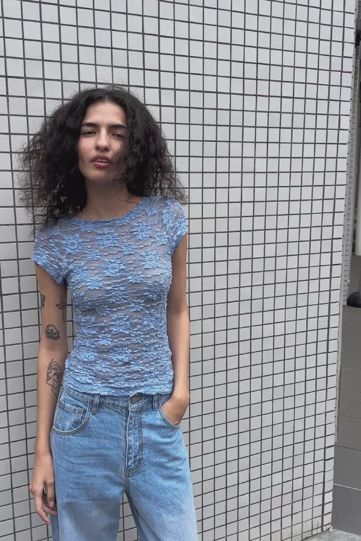 Video of model wearing Percy Curve Seam Jeans in Faded Blue, styled with the Galo Sunflower Lace Tee in Periwinkle by ROWIE the Label, filmed on a Tokyo street.