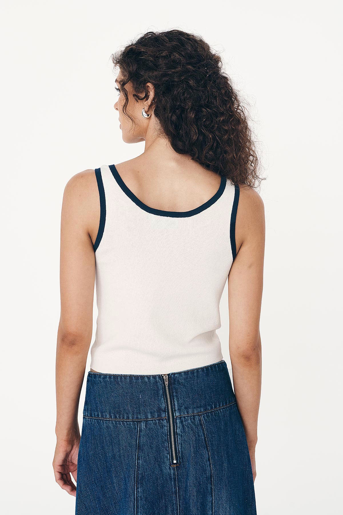 Back studio view of model wearing a Blake Contrast Knit Tank top in cream with Ink blue trim, styled with the Vashti Denim Midi Skirt by ROWIE the Label.