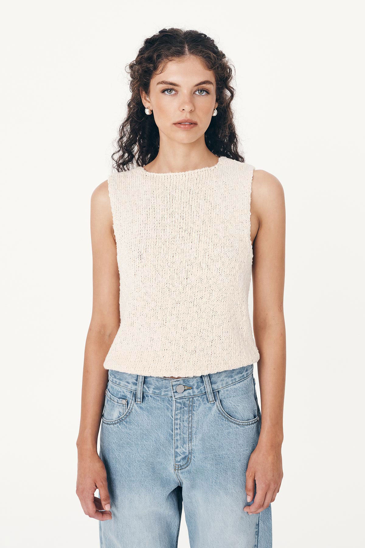 Model wearing a Catalina Knit Tank in Creme, paired with the Percy Curve Seam Jeans in Faded Blue by ROWIE the Label, front studio view.