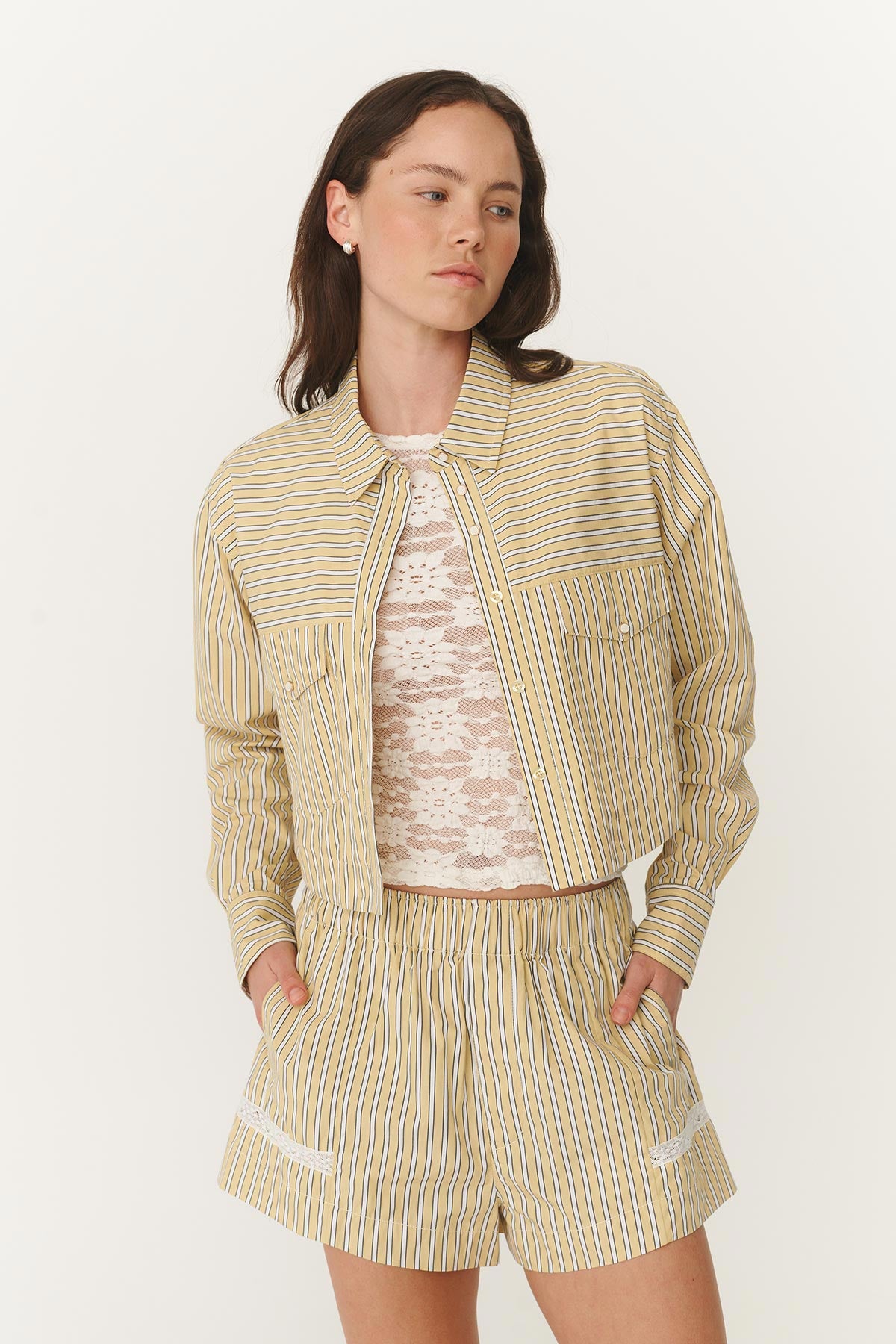 Cole Stripe Crop Shirt unbuttoned and open showing the White Galo Lace Top underneath and paired with the Rocco Lace Boxer shorts in matching stripe print