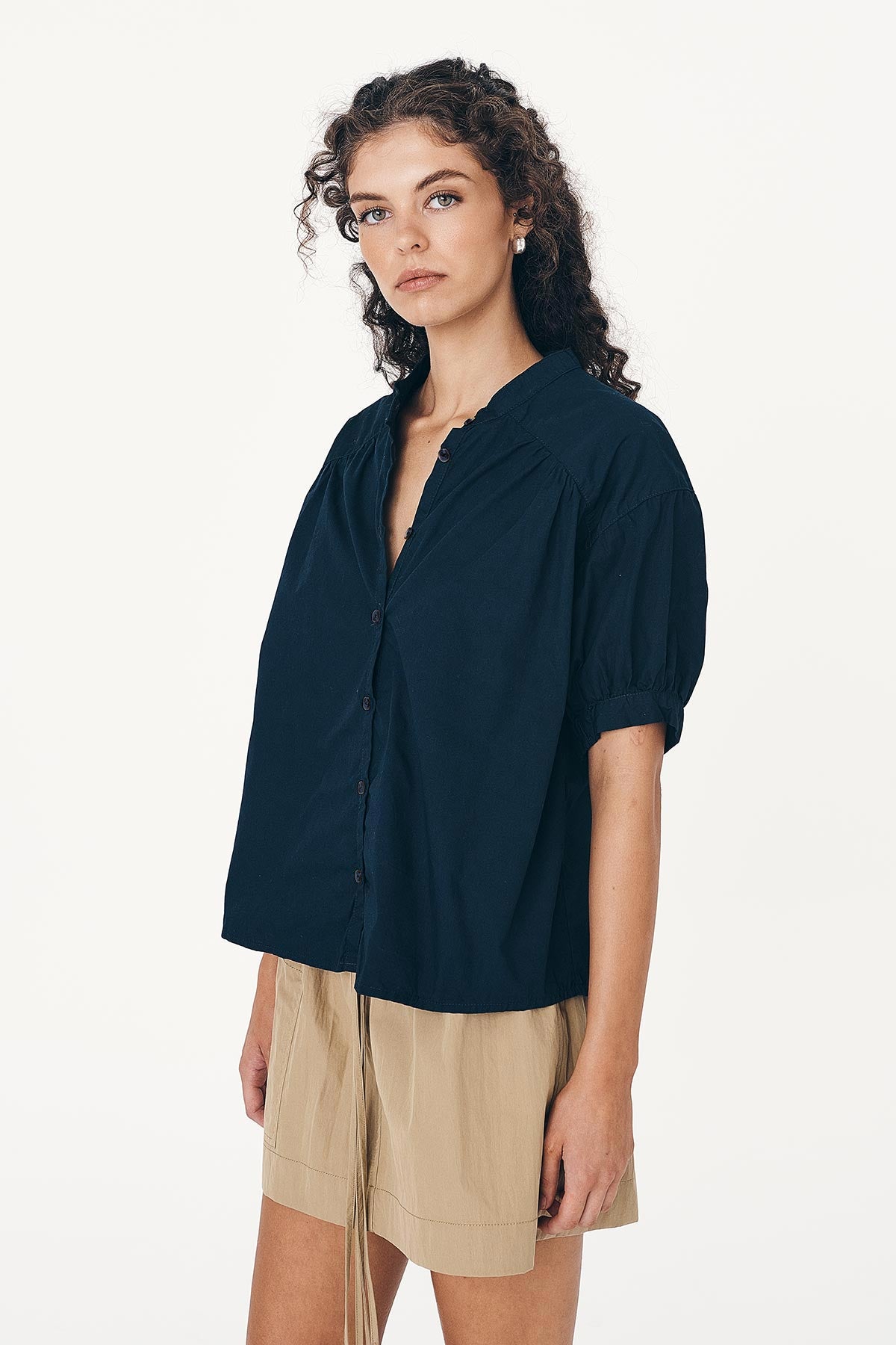 Angled studio view of model wearing a Cora Spring Blouse in Ink Cotton, styled with the Jessica Cargo Mini Skirt in Washed Khaki by ROWIE the Label.