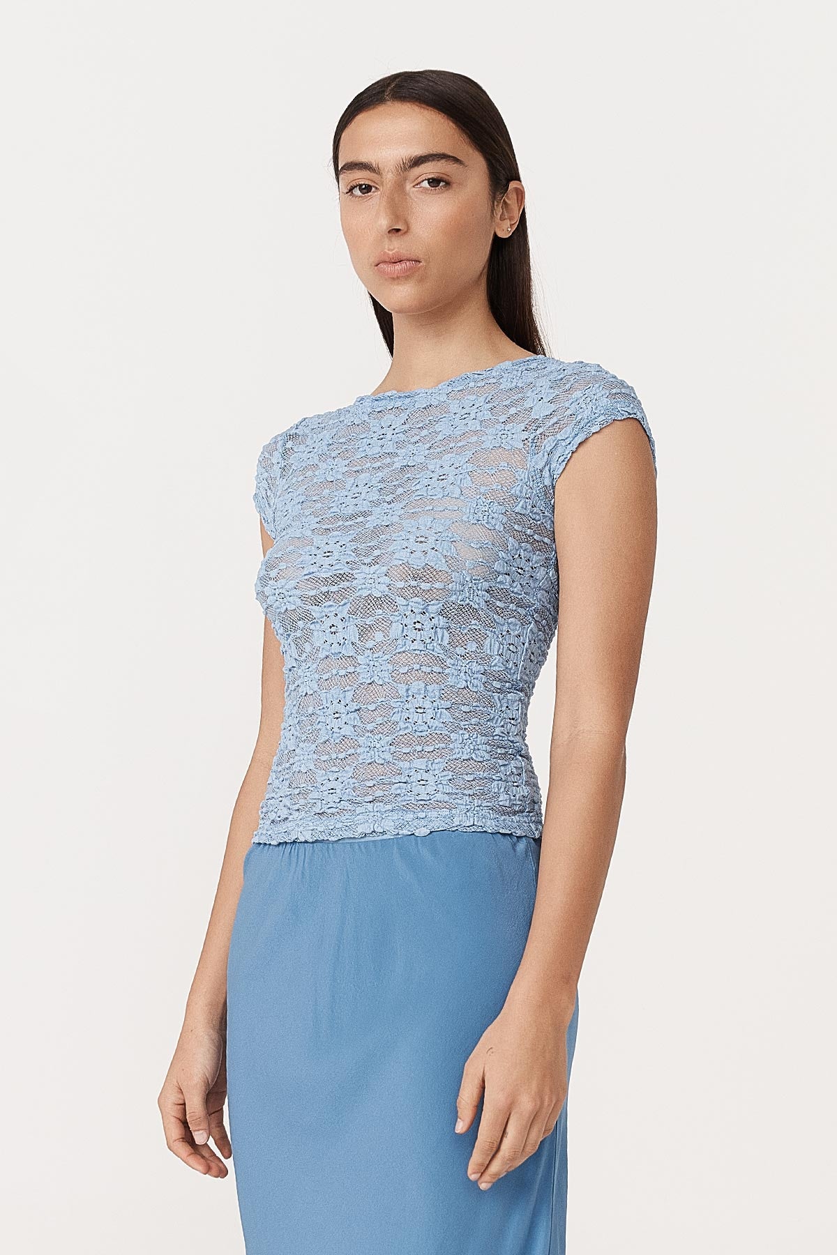 Angled side studio view of model wearing a Galo Sunflower Lace Tee in Periwinkle, styled with the Marina Silk Midi Skirt in Cornflower by ROWIE the Label.