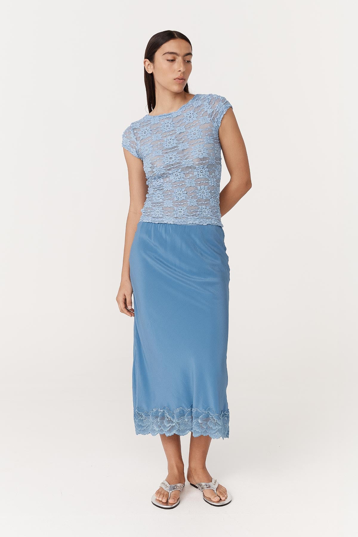 Full-body studio view of model wearing a Galo Sunflower Lace Tee in Periwinkle, paired with the Marina Silk Midi Skirt in Cornflower by ROWIE the Label.