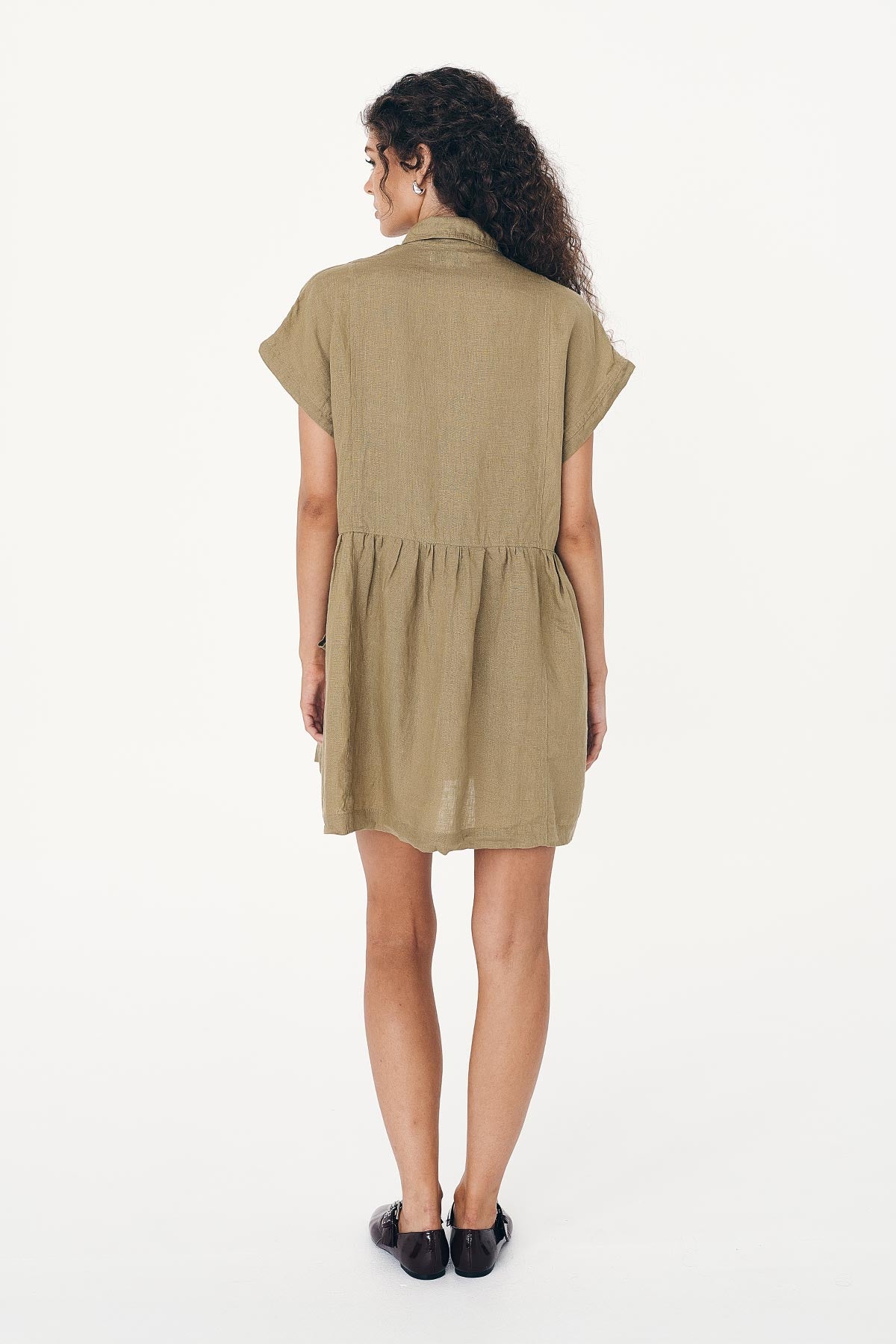 Back studio view of model wearing a Gina Linen Mini Dress in Dusty Olive by ROWIE the Label.