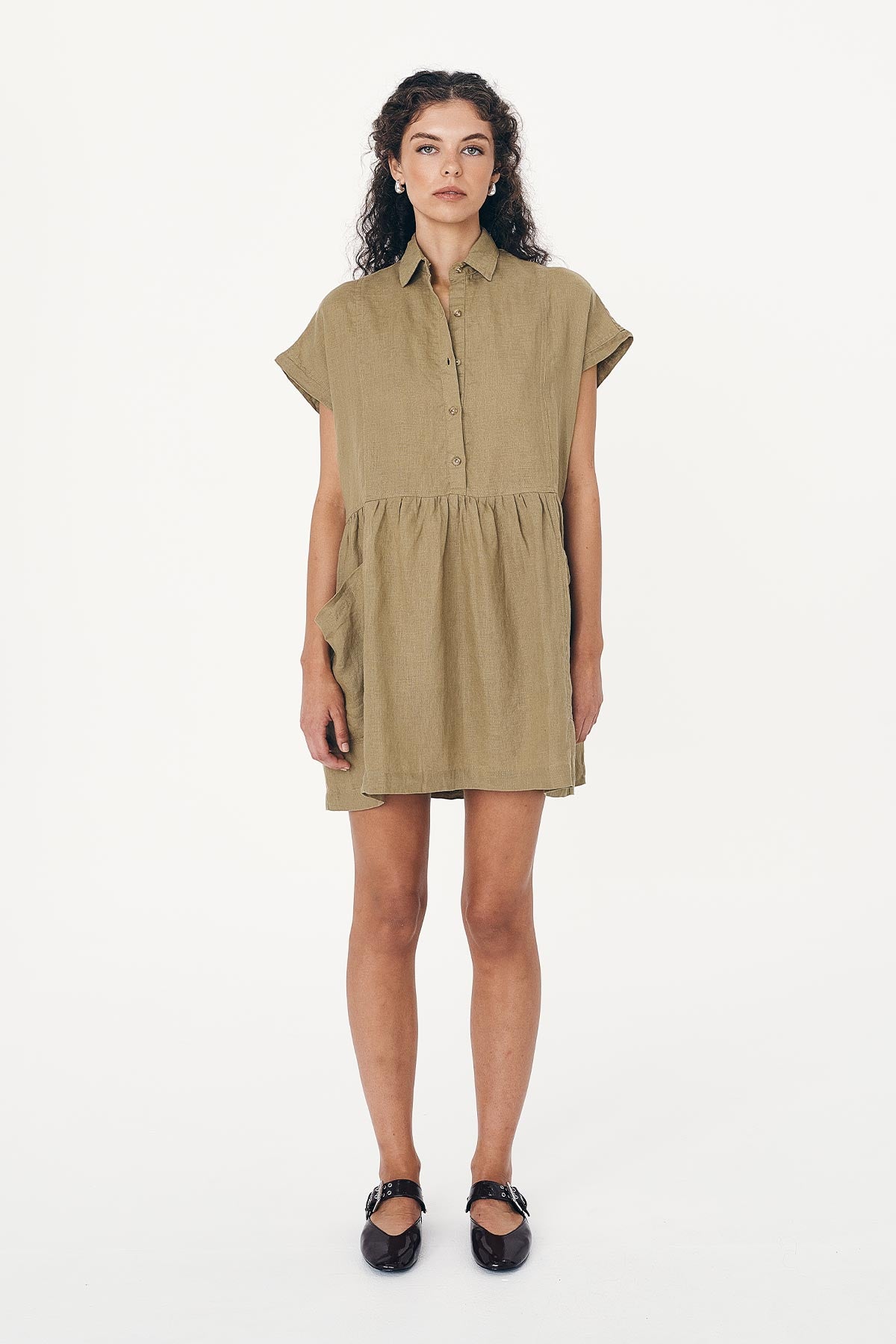 Model wearing a Gina Linen Mini Dress in Dusty Olive by ROWIE the Label, front studio view.