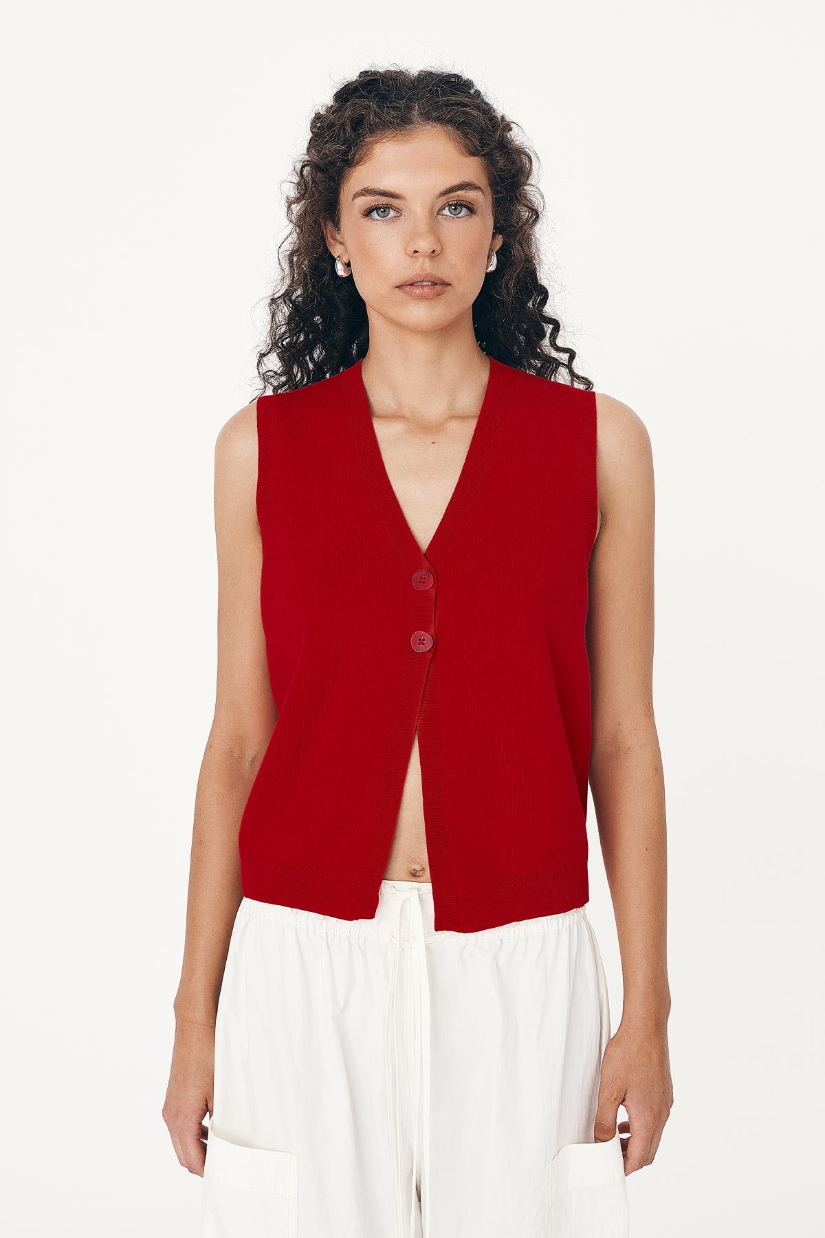 Model wears Goldie Cotton Knit Vest in Red, paired with Jessica Cargo Pants in White