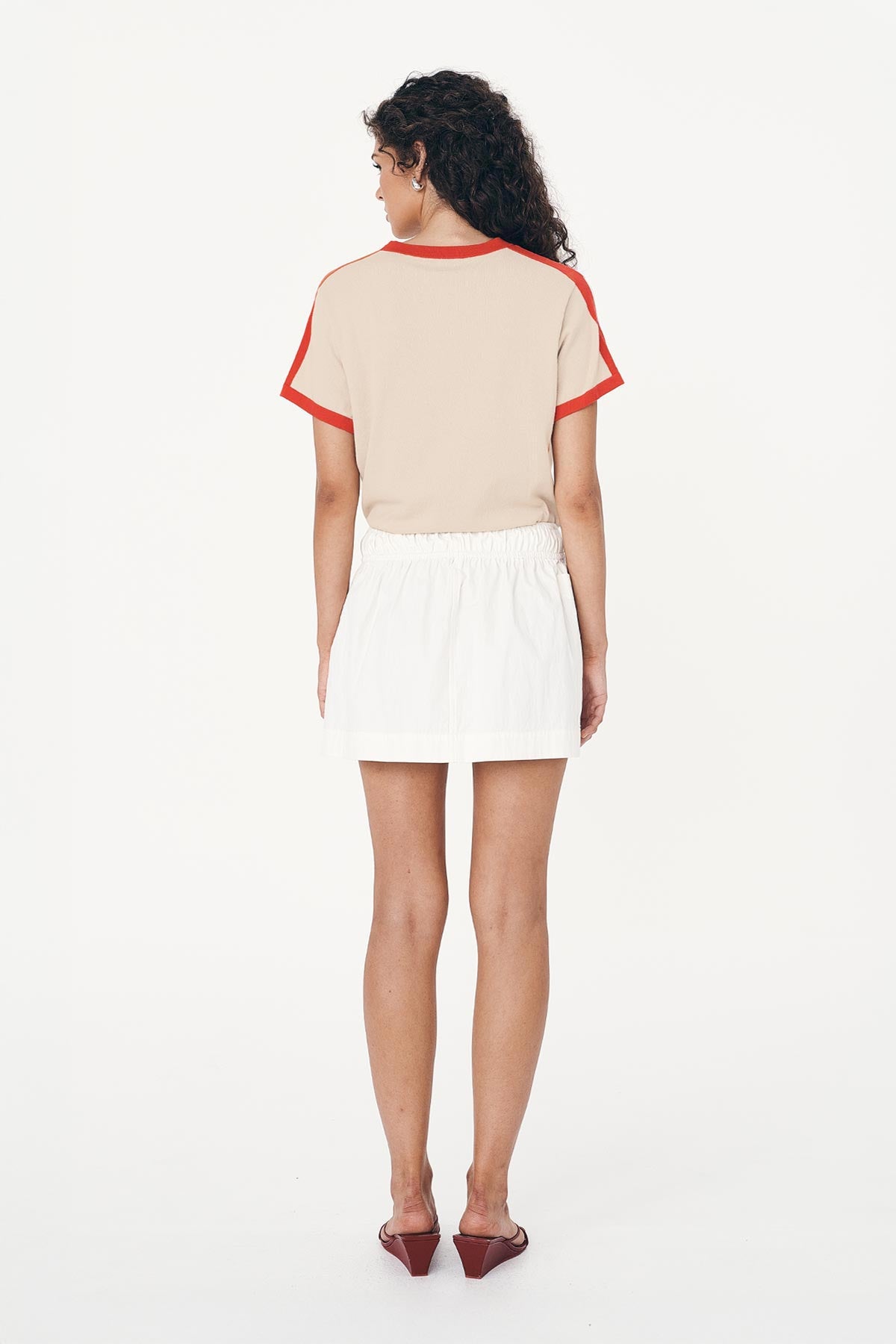 Jessica Cargo Mini Skirt in White paired with a Rania Contrast Knit Tee in Spiced Latte, showing detail from behind