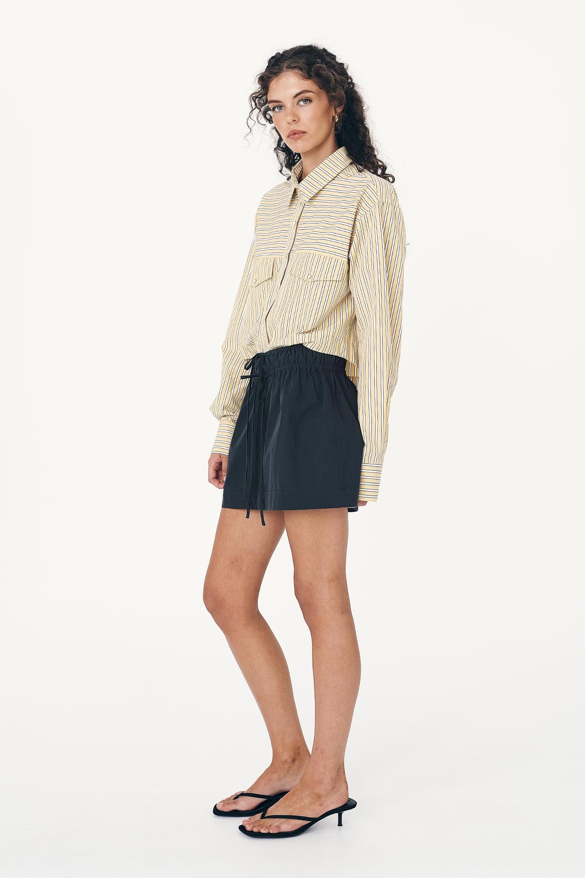 Model wears Black Cargo Mini Skirt, paired with the Cole Stripe Crop Shirt in Sunflower Yellow