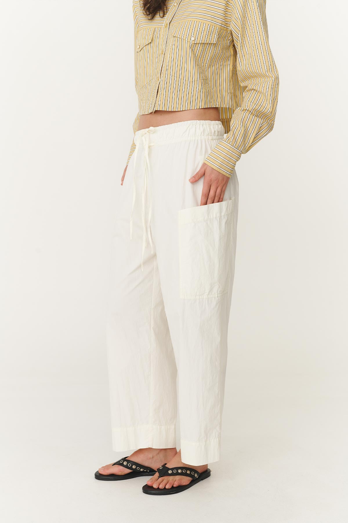 Close up of the Jessica Cargo Pants in White, highlighting the oversized front patch pockets, slightly tapered leg and relaxed fit