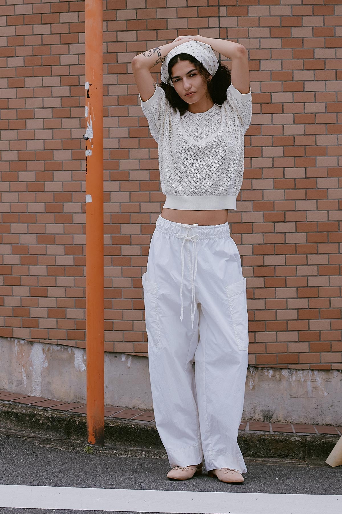 Jessica Cargo Pants in White with oversized front patch pockets and double tie detail. Paired with a Loretta Pointelle Knit Polo Top and Frannie Silk Scarf worn around the hair