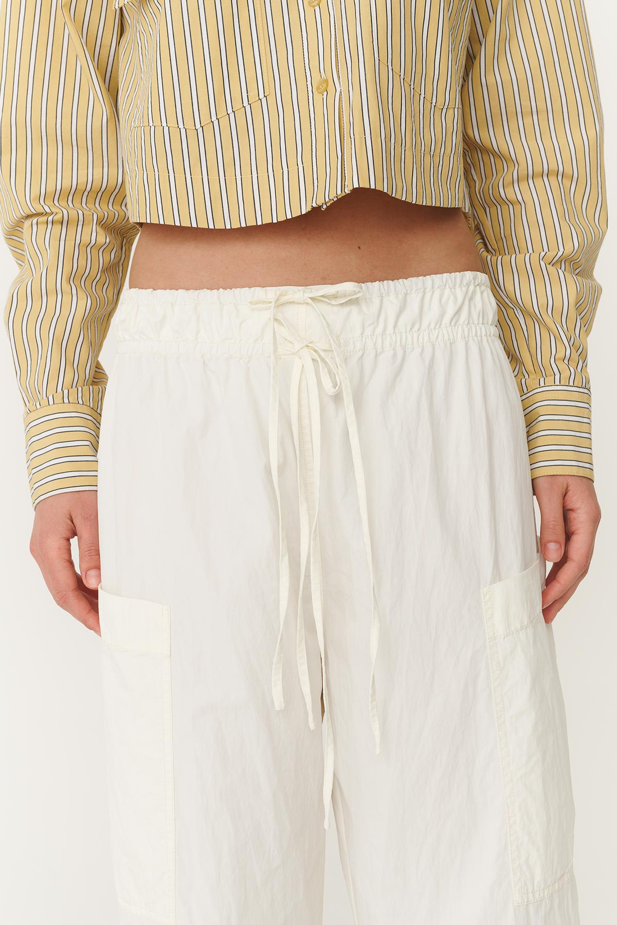 Close up of the Jessica Cargo Pants in White, highlighting the double tie detail and front pockets.