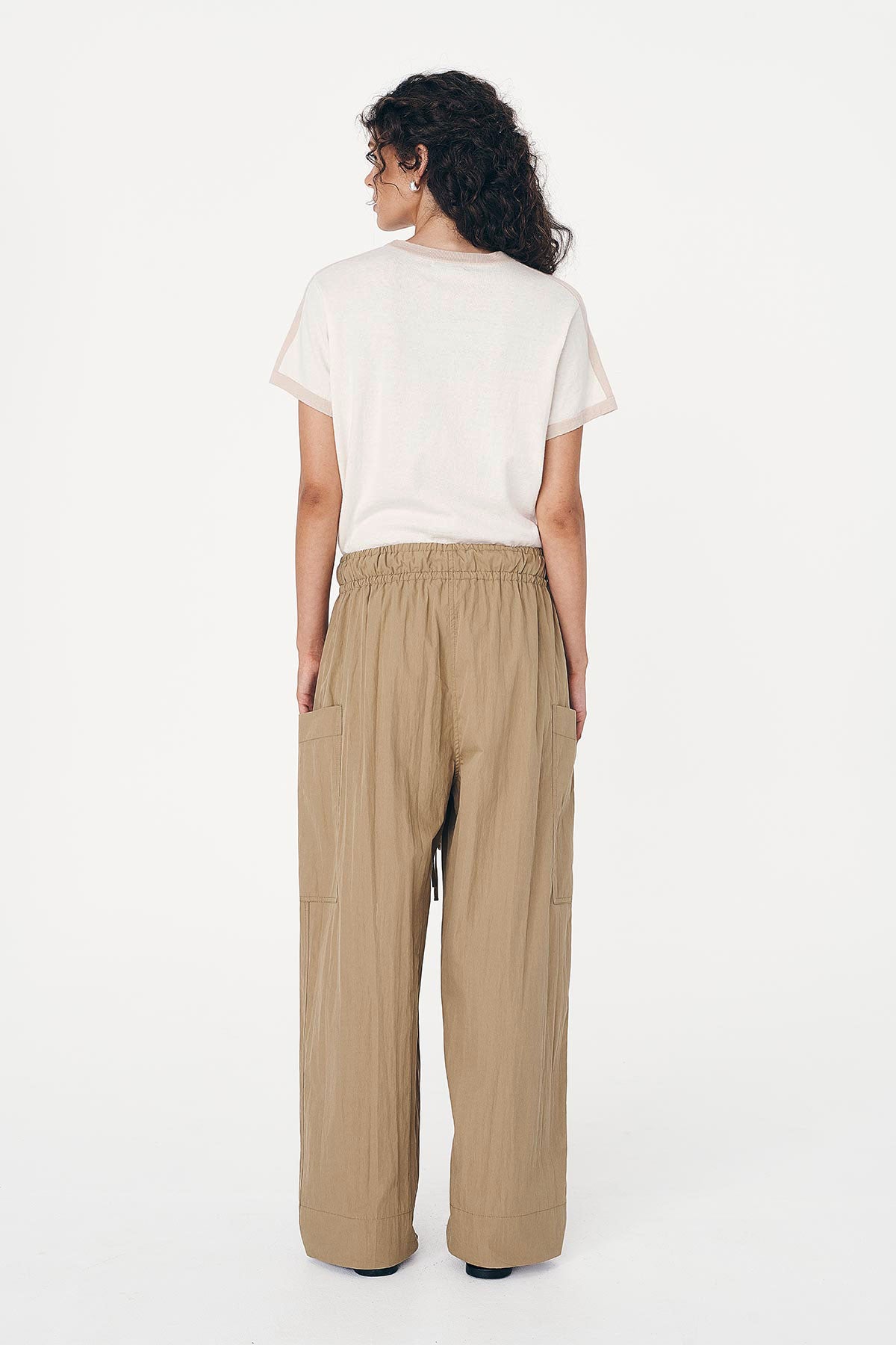 Back studio view of model wearing Jessica Cargo Pants in Washed Khaki, styled with the Rania Contrast Knit Tee in Oat Milk by ROWIE the Label.