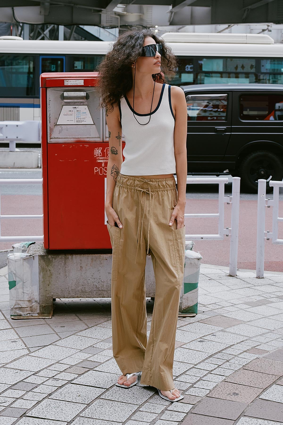 Model wearing Jessica Cargo Pants in Washed Khaki, styled with the Blake Contrast Knit Tank in Ink by ROWIE the Label, lifestyle shot on a Tokyo street.