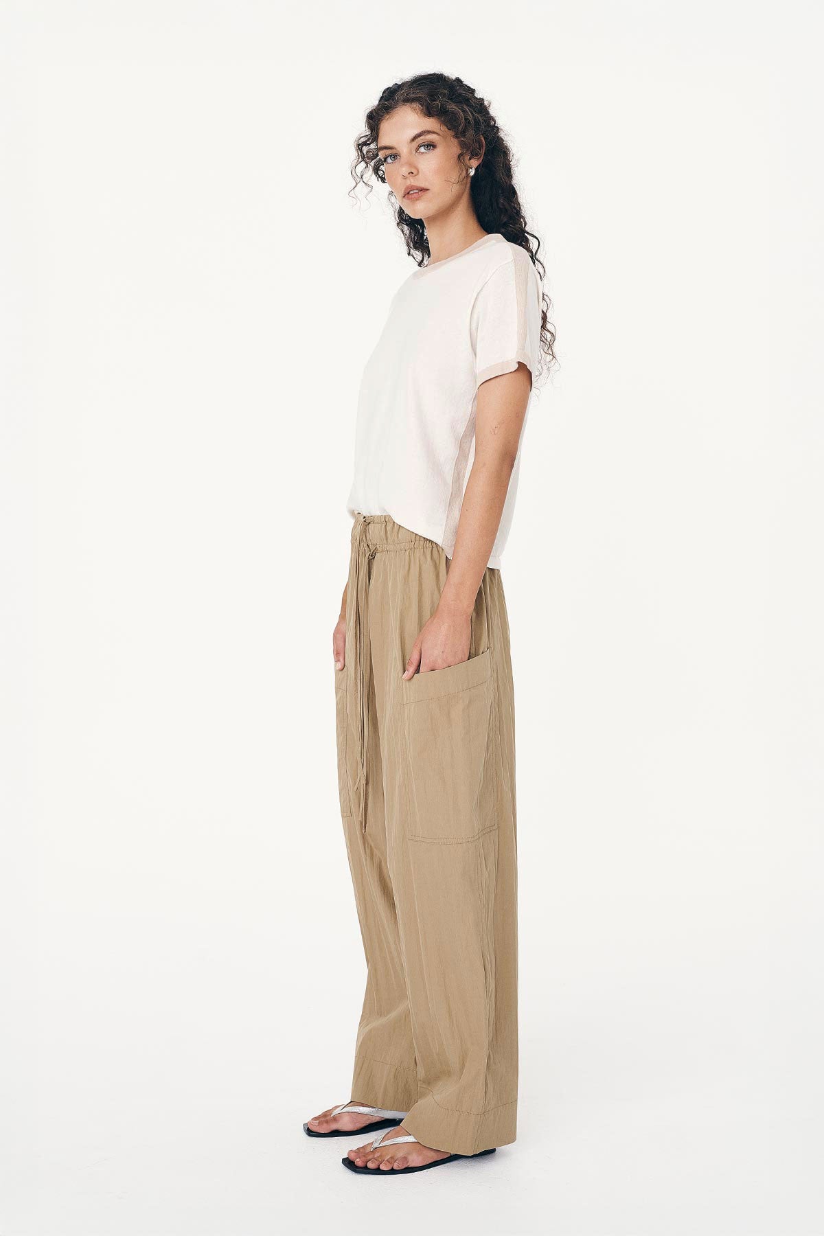Angled side studio view of model wearing Jessica Cargo Pants in Washed Khaki, styled with the Rania Contrast Knit Tee in Oat Milk by ROWIE the Label.
