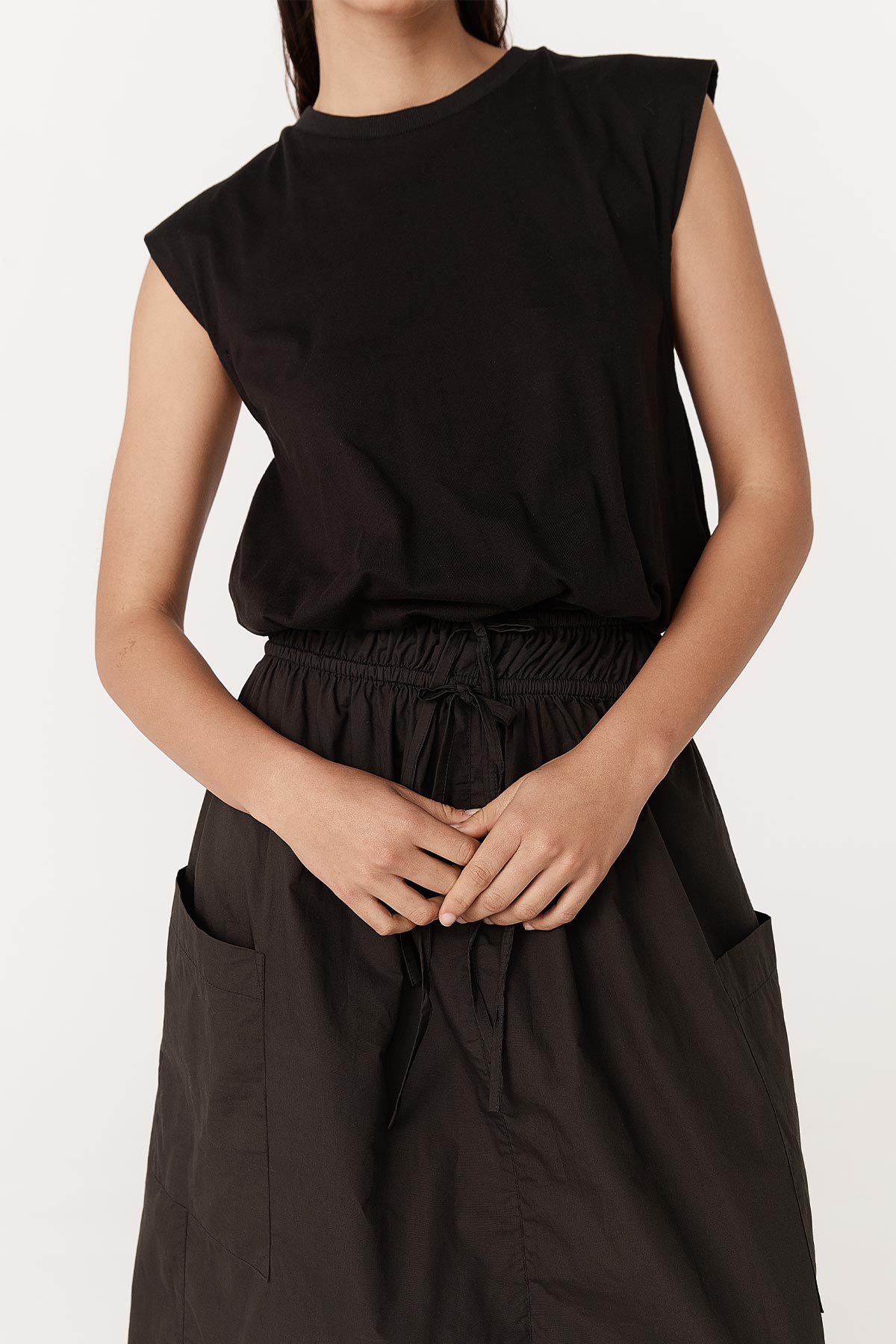 Close-up studio view of Jessica Organic Midi Dress in Tonal Noir by ROWIE the Label, showing rolled sleeves and poplin skirt detail.