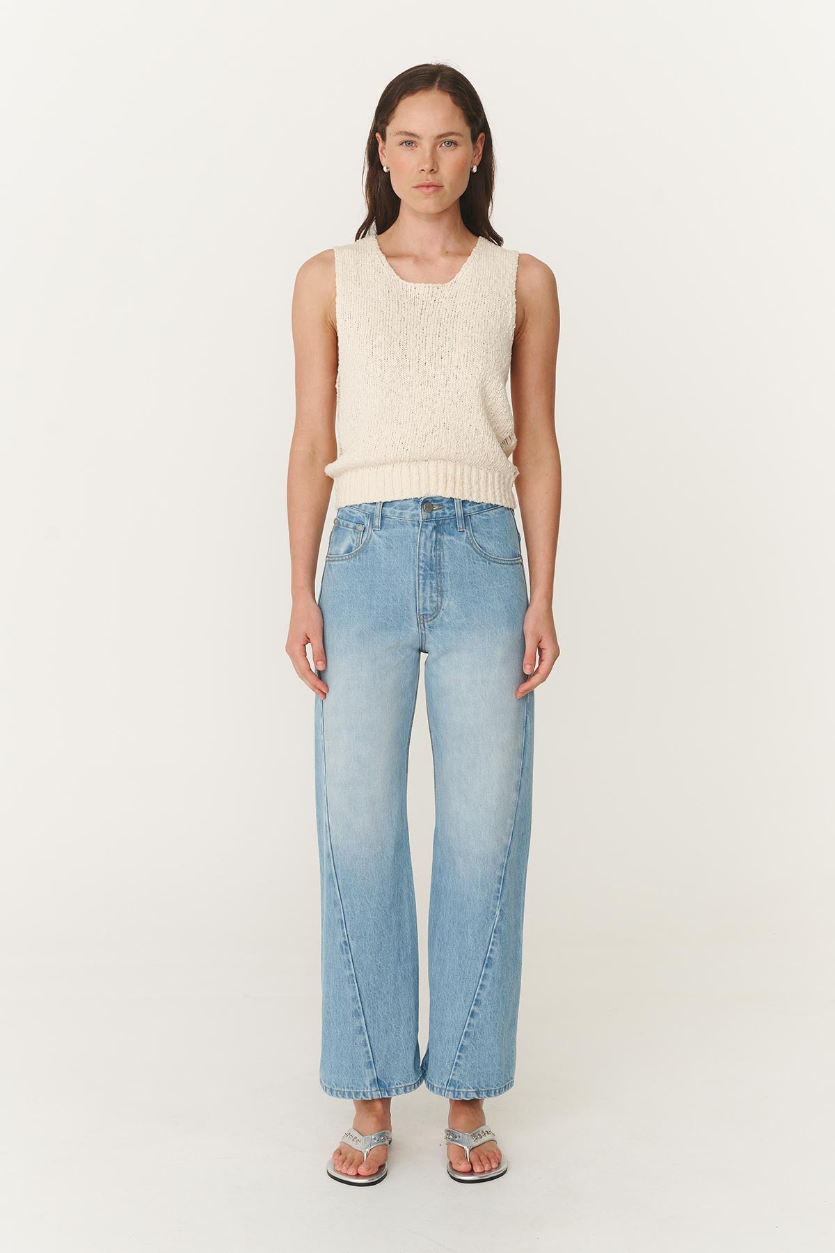 Model wearing Percy Curve Seam Jeans in Faded Blue, paired with the Catalina Knit Tank in Creme by ROWIE the Label, front studio view.