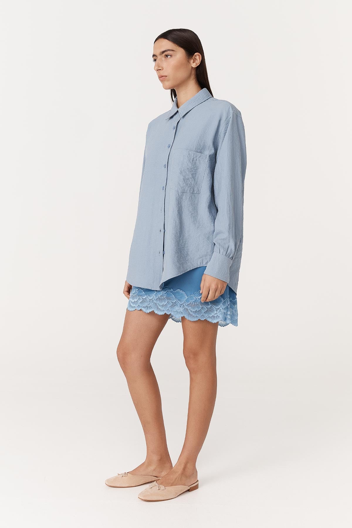 Full-body studio view of model wearing a Ramona Silk Long Sleeve Shirt in Periwinkle, styled with the Marina Silk Mini Skirt in Cornflower by ROWIE the Label.