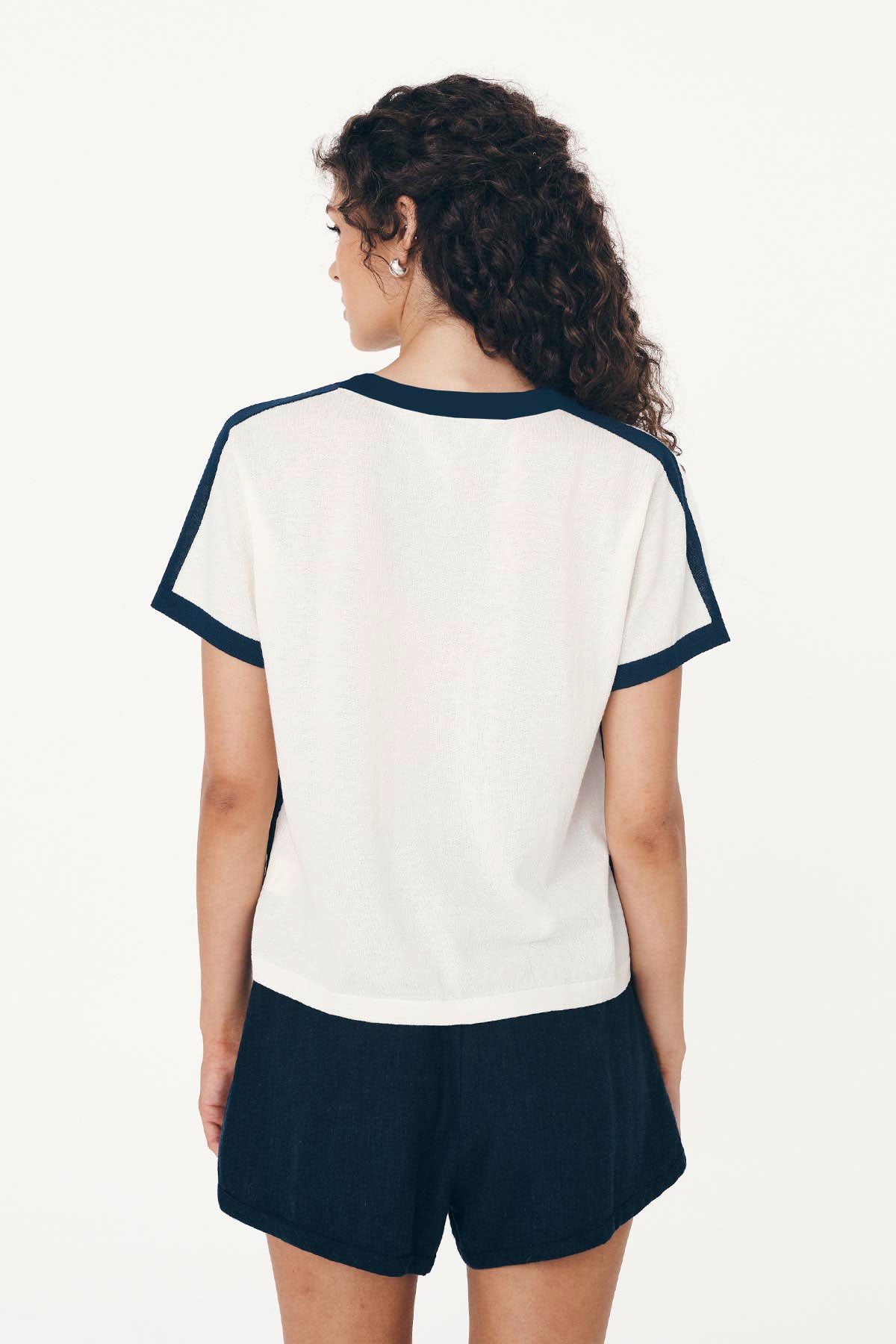 Back studio view of model wearing a Rania Contrast Knit Tee in Ink, styled with the Suri Lace Mini Skirt in Bone by ROWIE the Label.