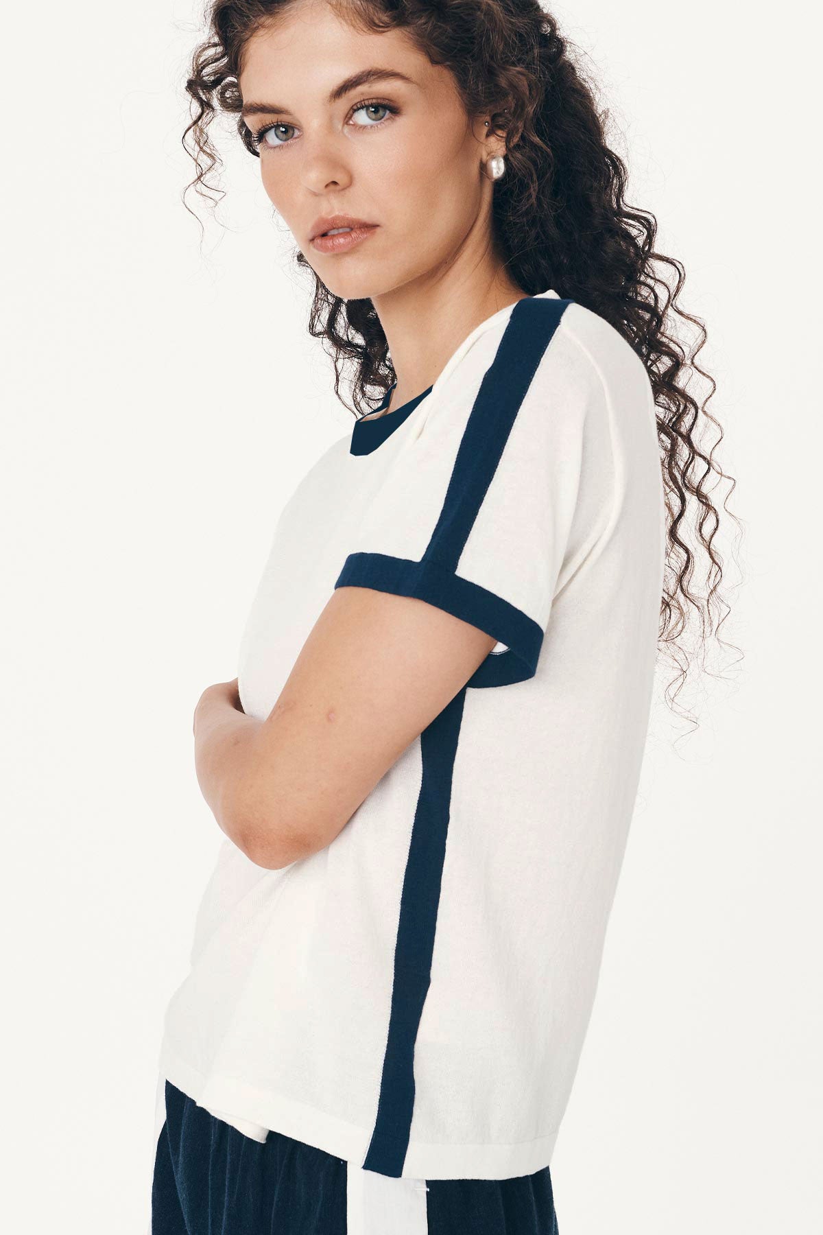 Angled studio view of model wearing a Rania Contrast Knit Tee in Ink, styled with the Suri Lace Mini Skirt in Bone by ROWIE the Label.