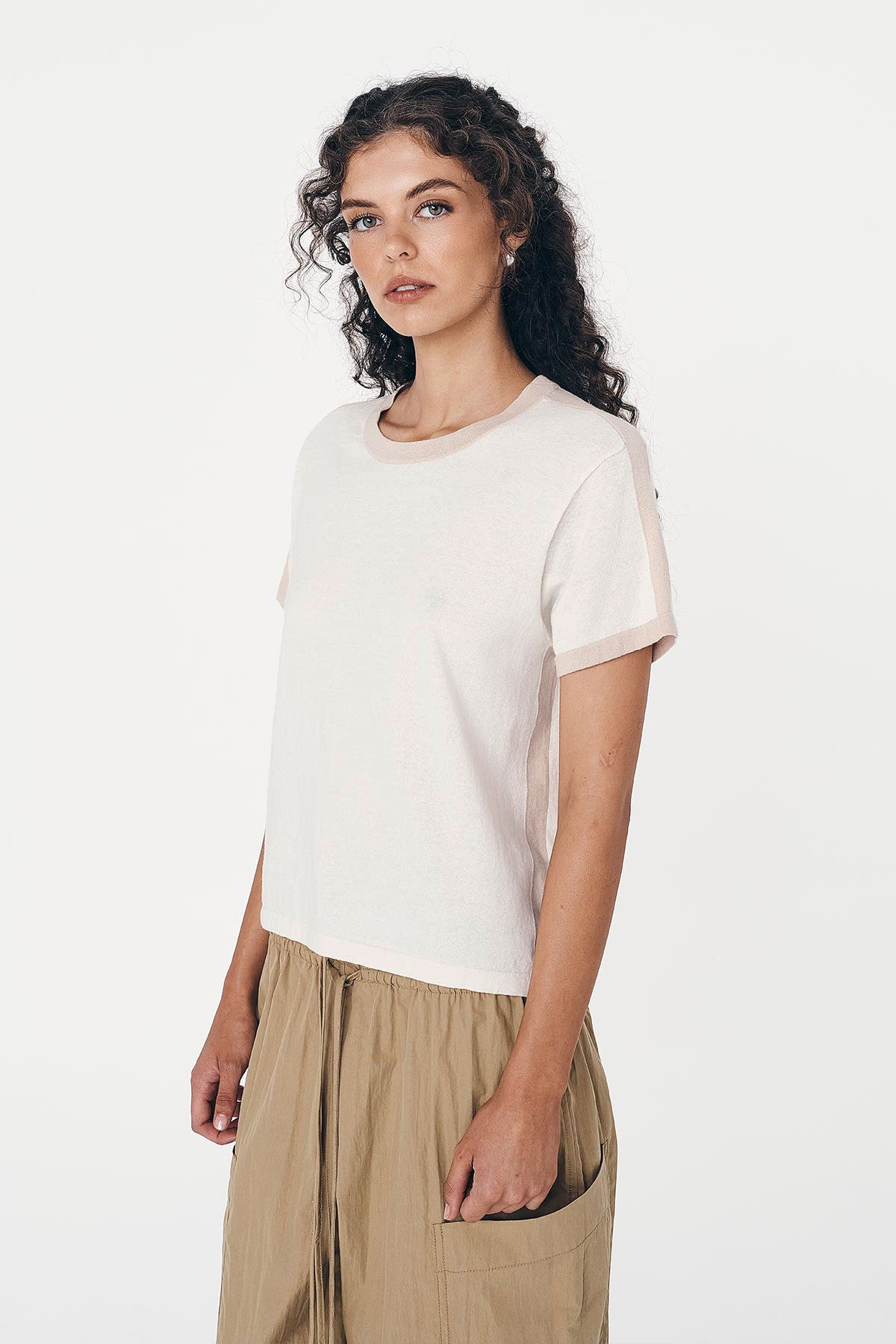 Angled studio view of model wearing a Rania Contrast Knit Tee in Oat Milk, styled with the Jessica Cargo Pants in Washed Khaki by ROWIE the Label.