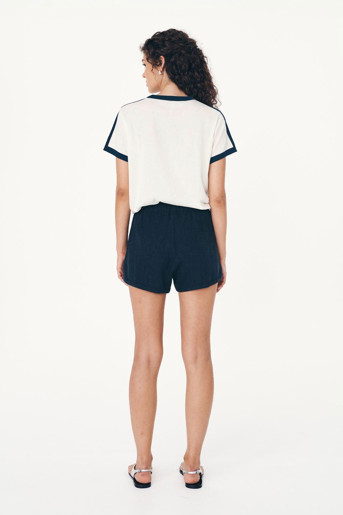 Back studio view of model wearing Simone Linen Shorts in Ink, styled with the Rania Contrast Knit Tee in Ink by ROWIE the Label.