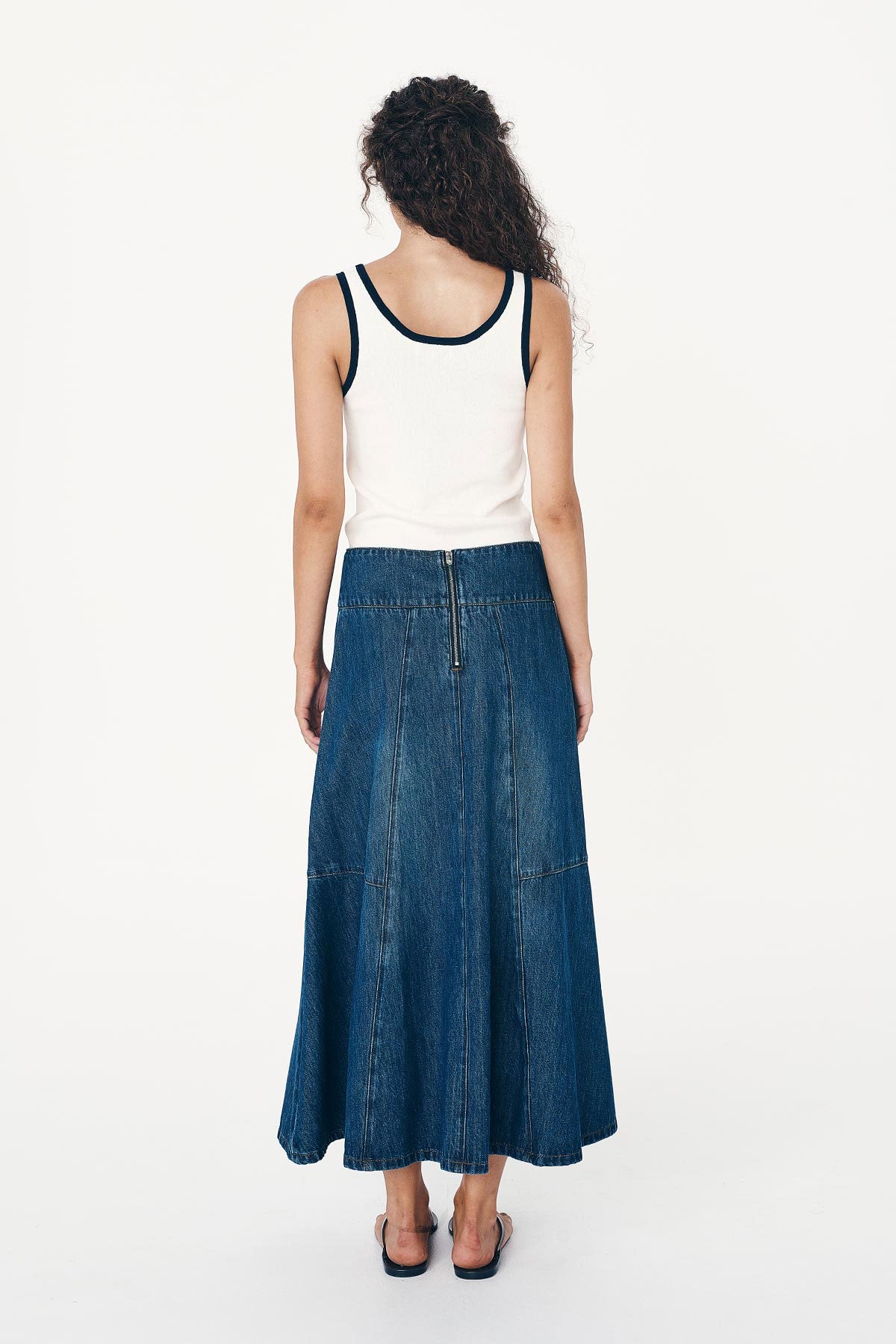 Back studio view of model wearing a Vashti Denim Midi Skirt in Classic Denim, styled with the Blake Contrast Knit Tank in Cream with Ink trim by ROWIE the Label.